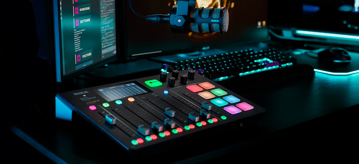 RODECaster Pro streaming setup with PodMic. Gaming computer and keyboard in background.