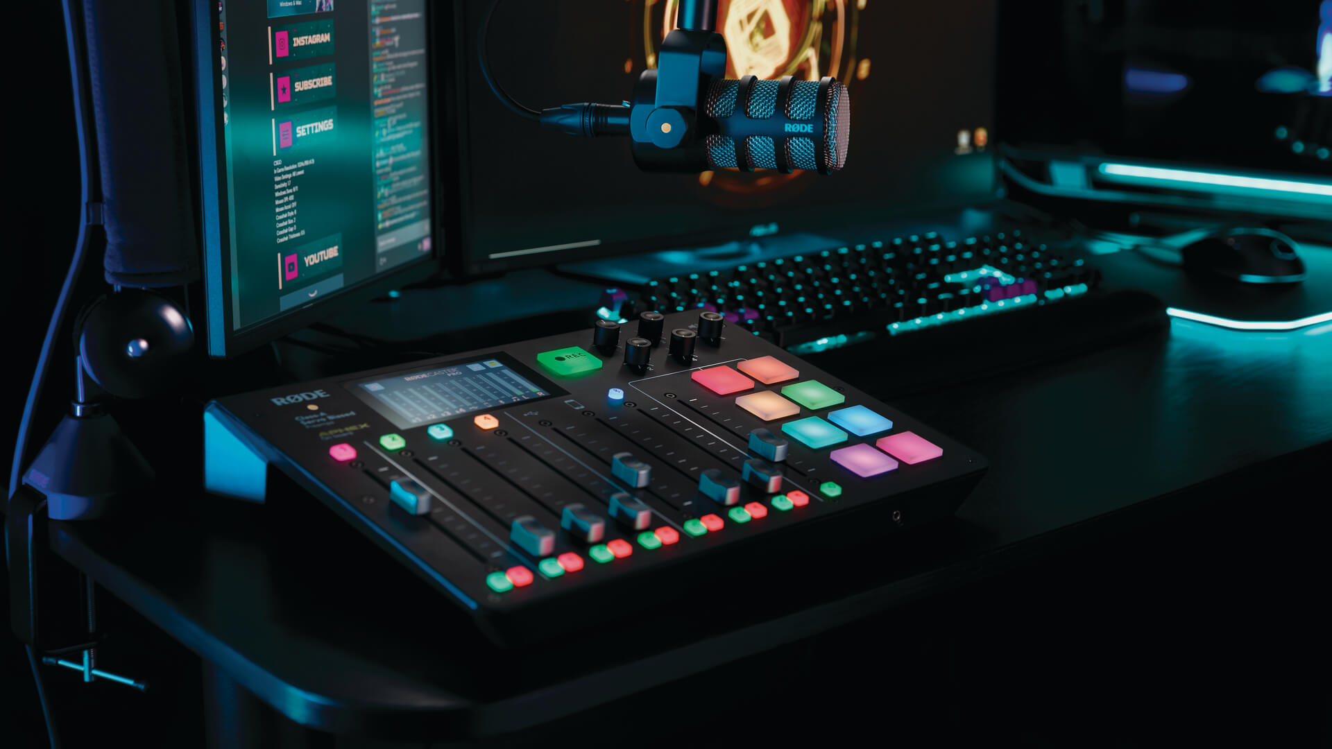 RODECaster Pro streaming setup showing PodMic with gaming computer and keyboard in background