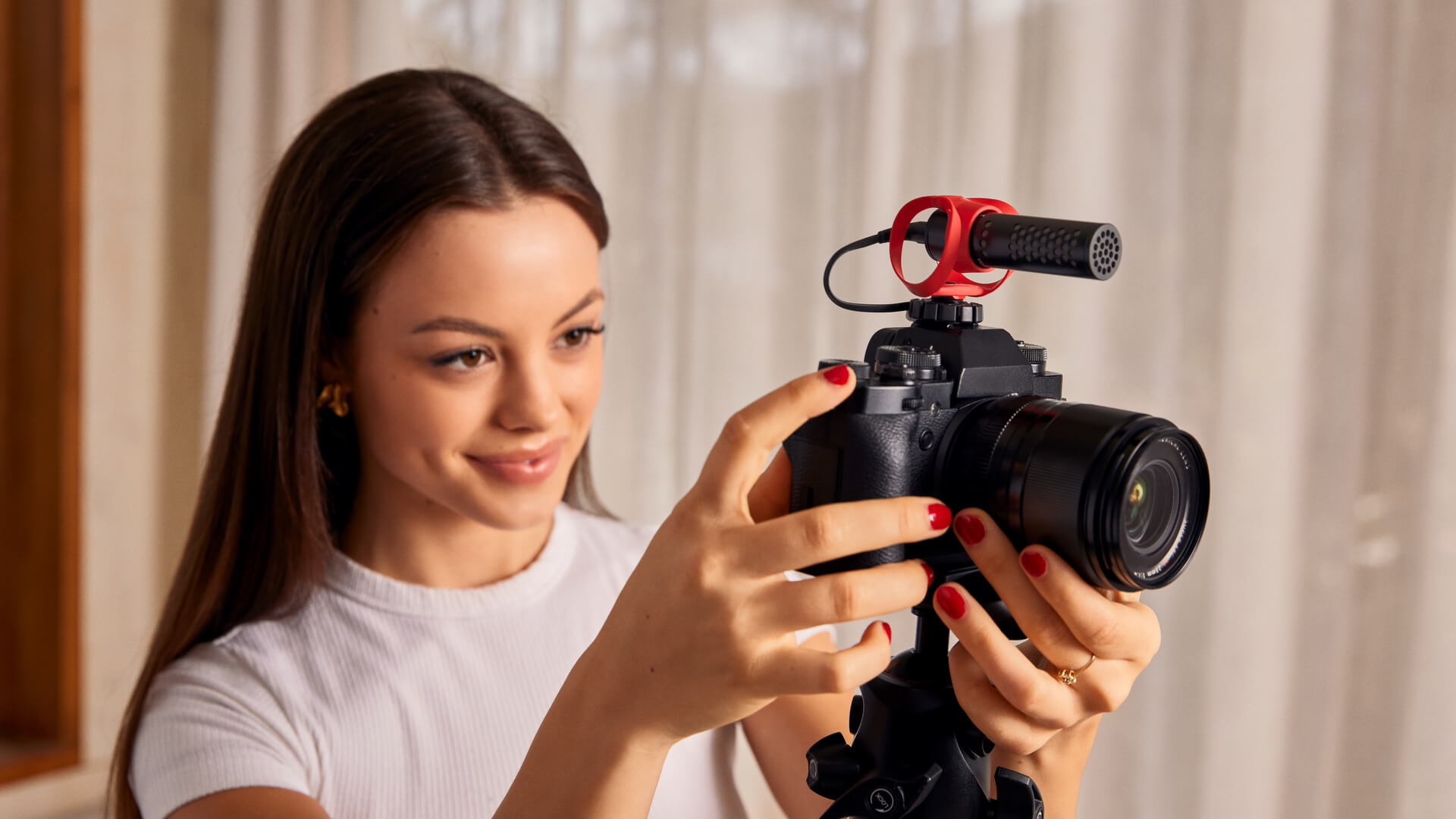 Girl holding camera with VideoMicro II mounted on
