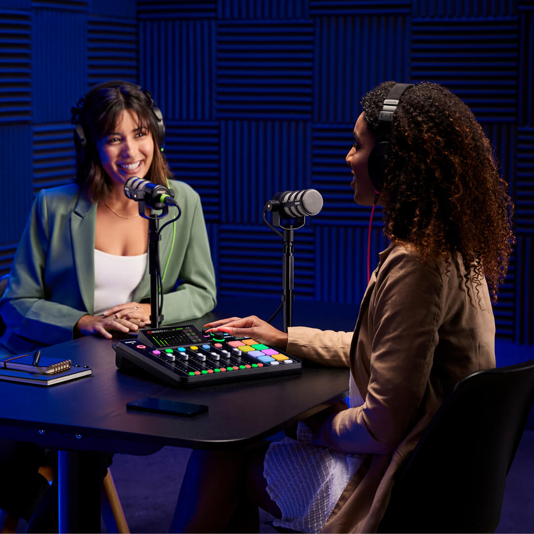Two podcasters wearing NTH-100 recording on RØDECaster Pro II with PodMic on DS1