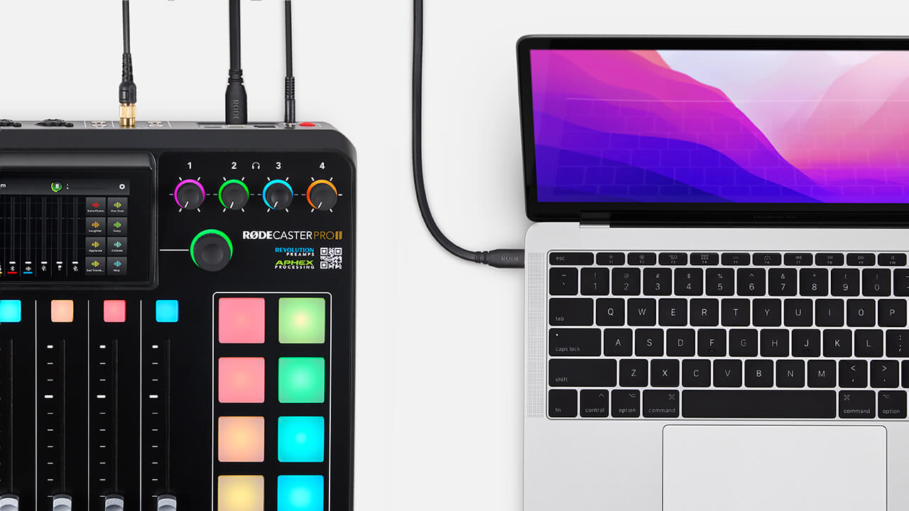 RØDECaster Pro II on white table connected to MacBook via USB-C cable