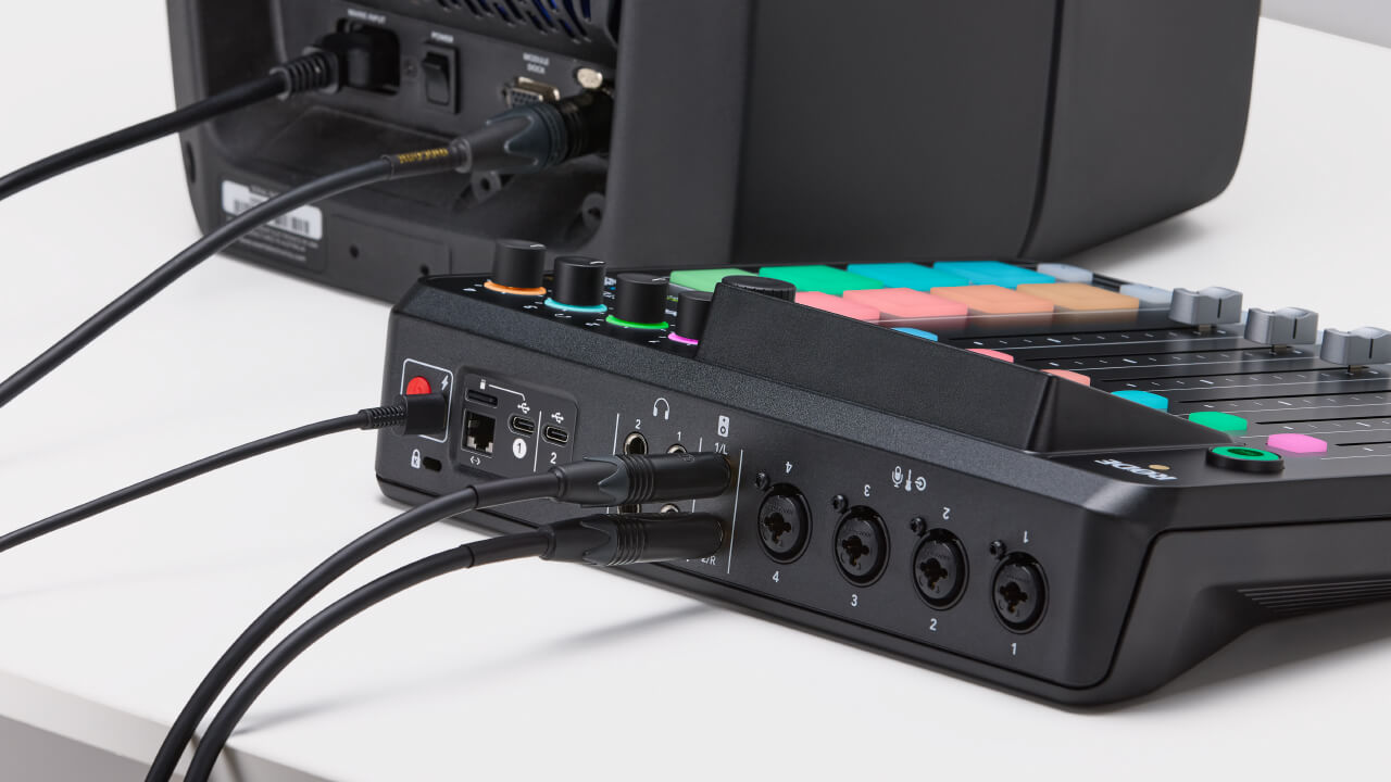 Back of RØDECaster Pro II showing speaker outputs connected