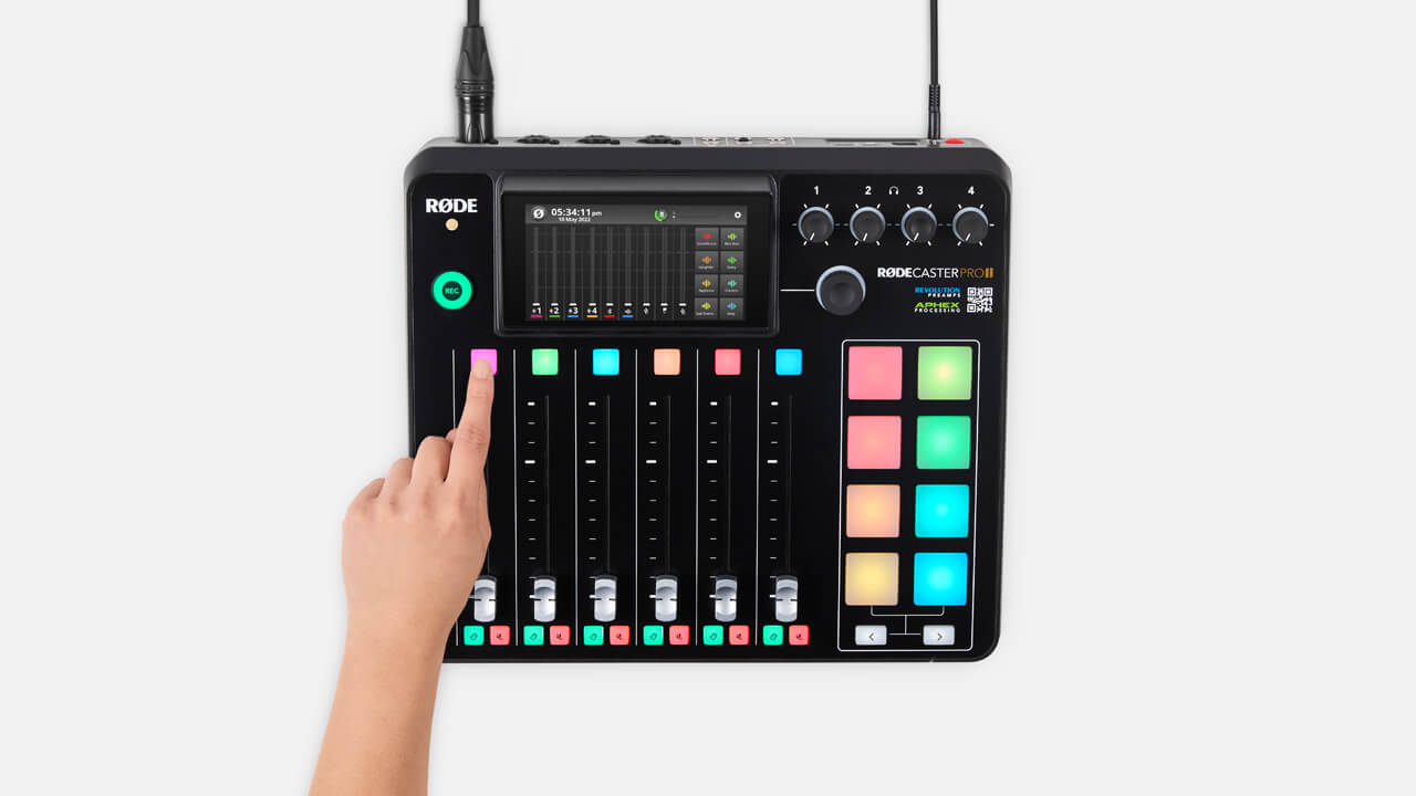 RØDECaster Pro II on white desk with NTH-100 and PodMic