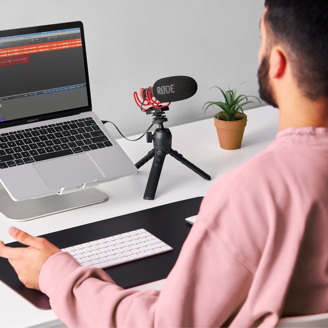 Man at laptop with VideoMic NTG on Tripod 2 connected