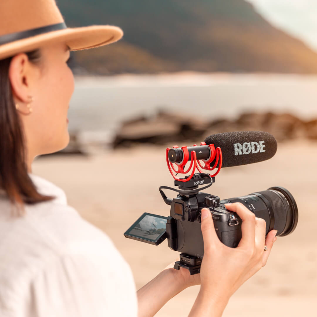 Girl using camera with VideoMic NTG outdoors