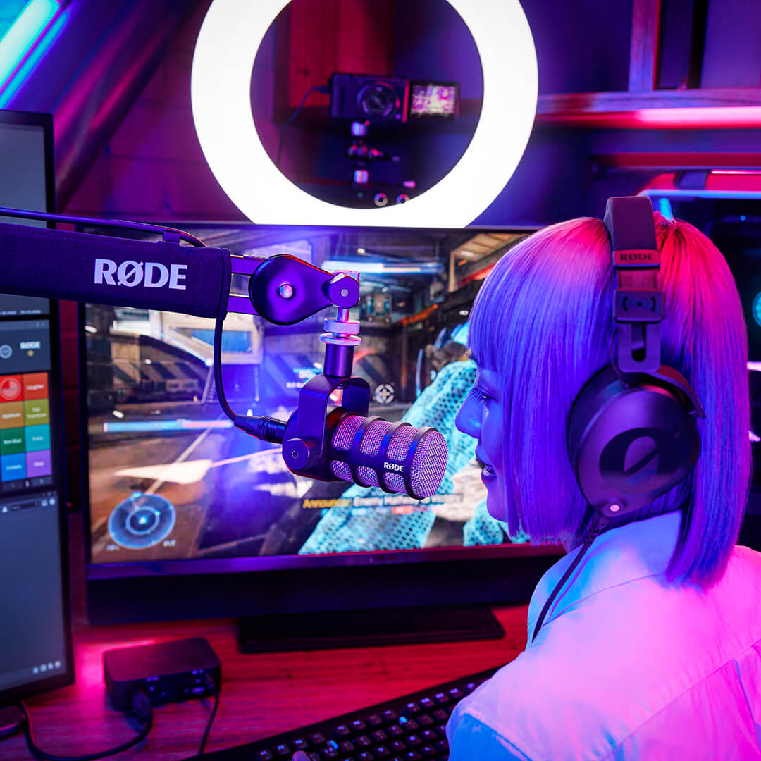 Girl wearing NTH-100 and talking into PodMic mounted to PSA1+ whilst gaming