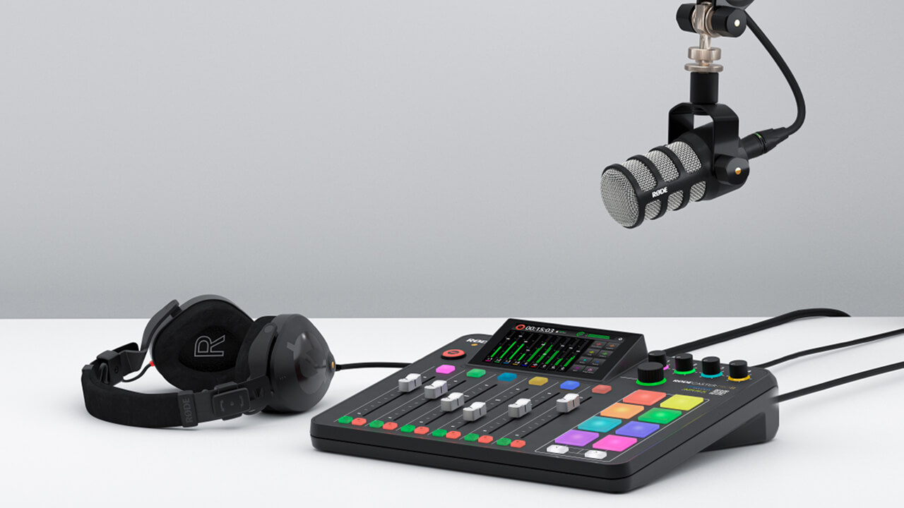 PodMic above RØDECaster Pro II on white table with NTH-100 next to it
