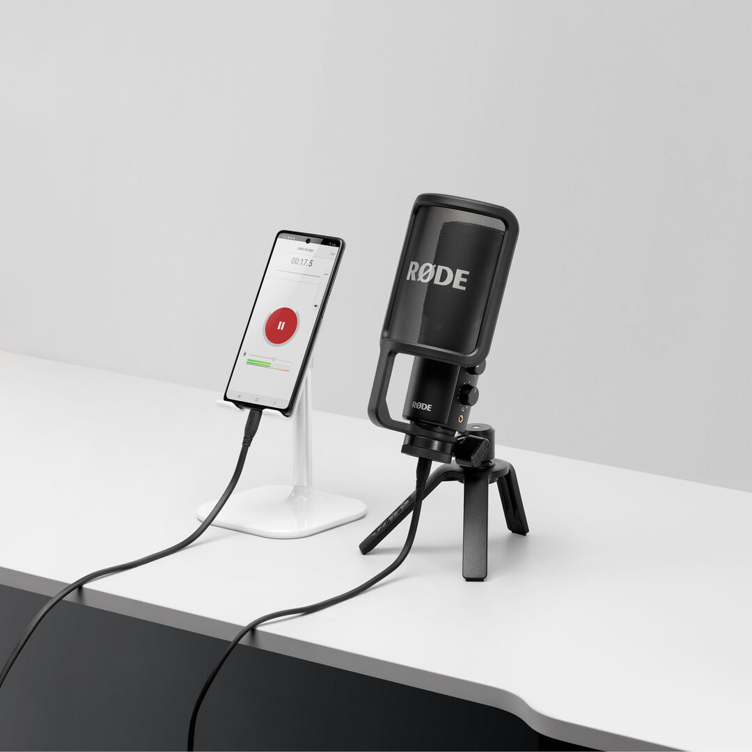 NT-USB+ on white desk connected to mobile phone showing RØDE Reporter