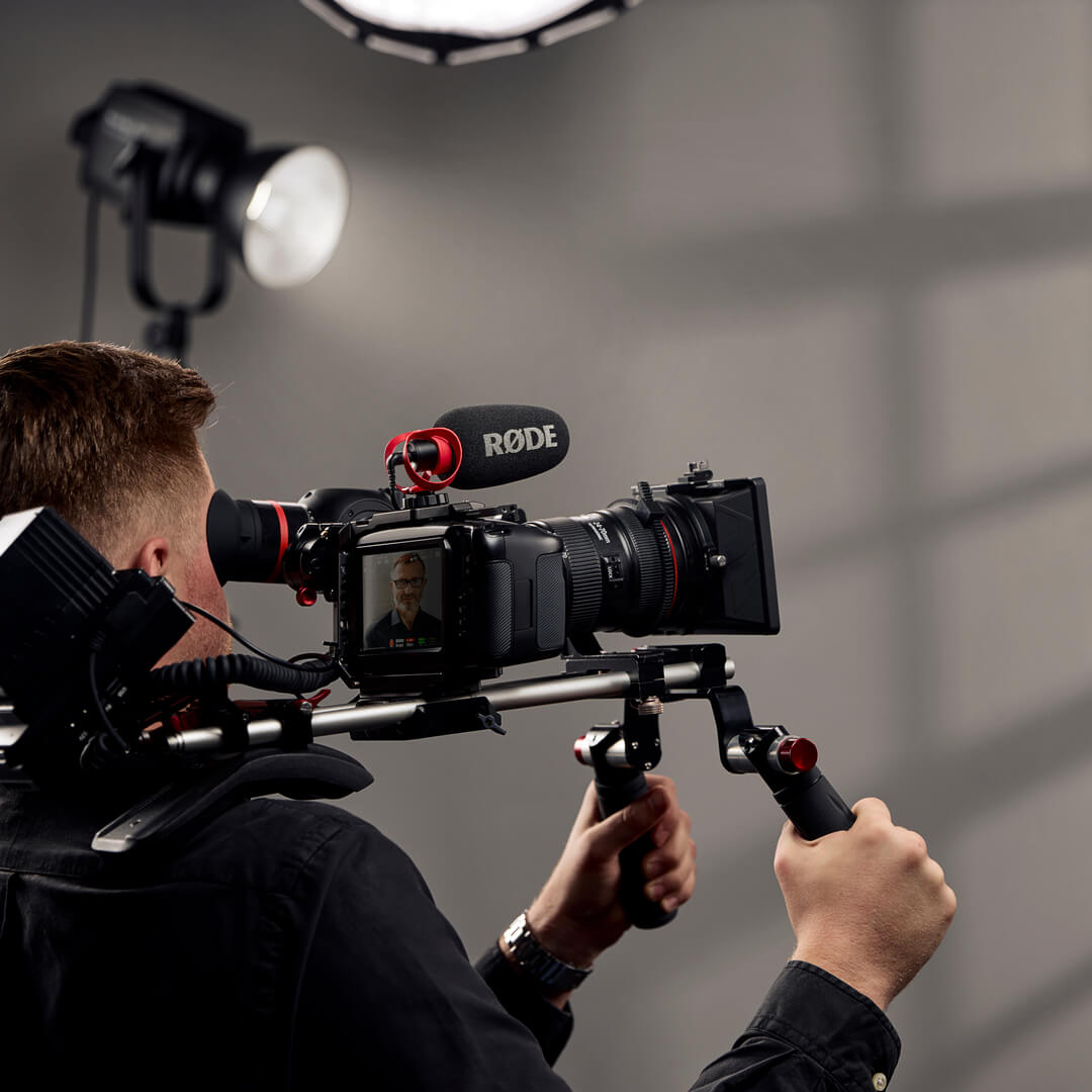 Cameraman with shoulder rig using VideoMicro II