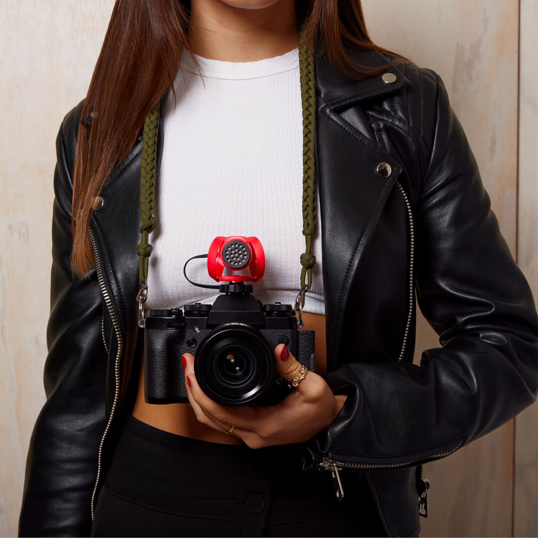 Girl wearing leather jacket holding camera with VideoMicro II