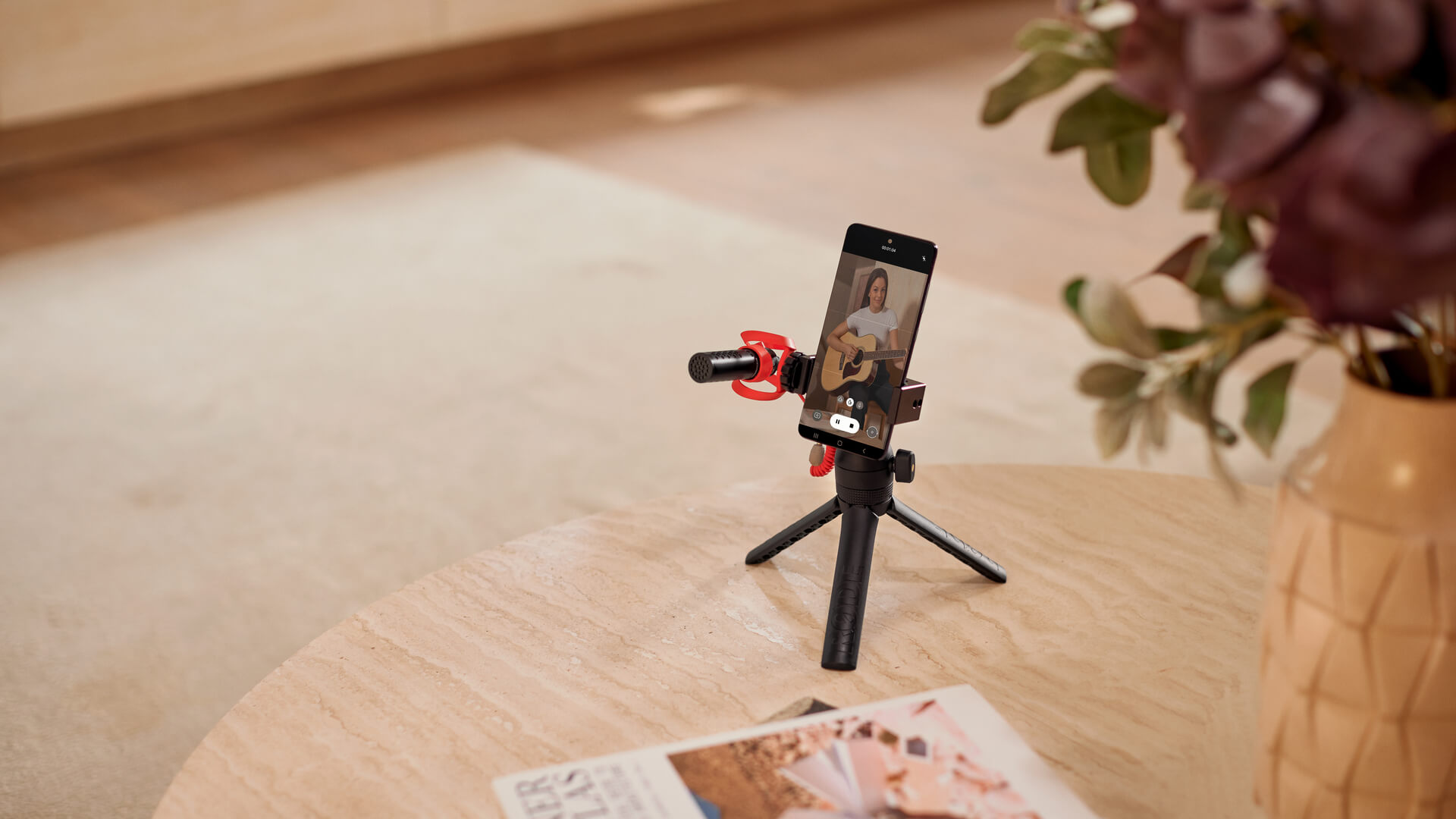Mobile phone with VideoMicro II connected and mounted to Tripod 2 on wooden table