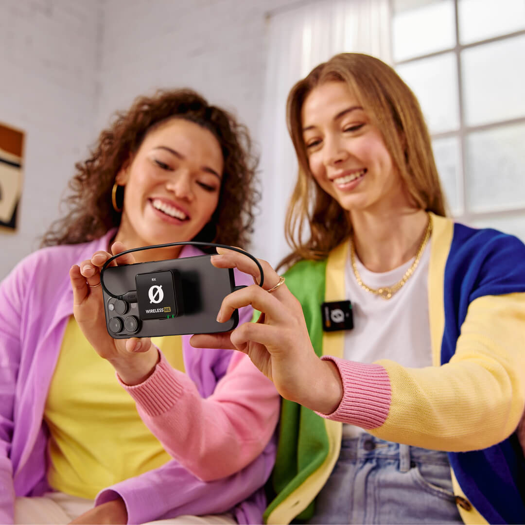 Two girls reviewing footage recorded on iPhone with Wireless ME