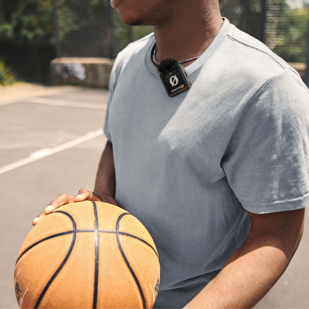 Person holding basketball and wearing Wireless ME