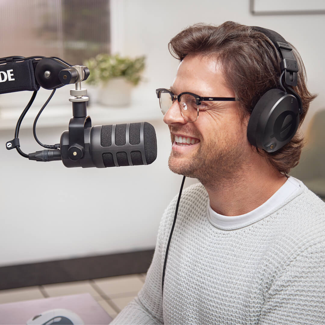 Man wearing NTH-100 speaking into PodMic USB attached to PSA1+