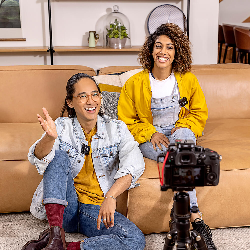 Couple in front of camera mounted on tripod with Wireless GO II connected