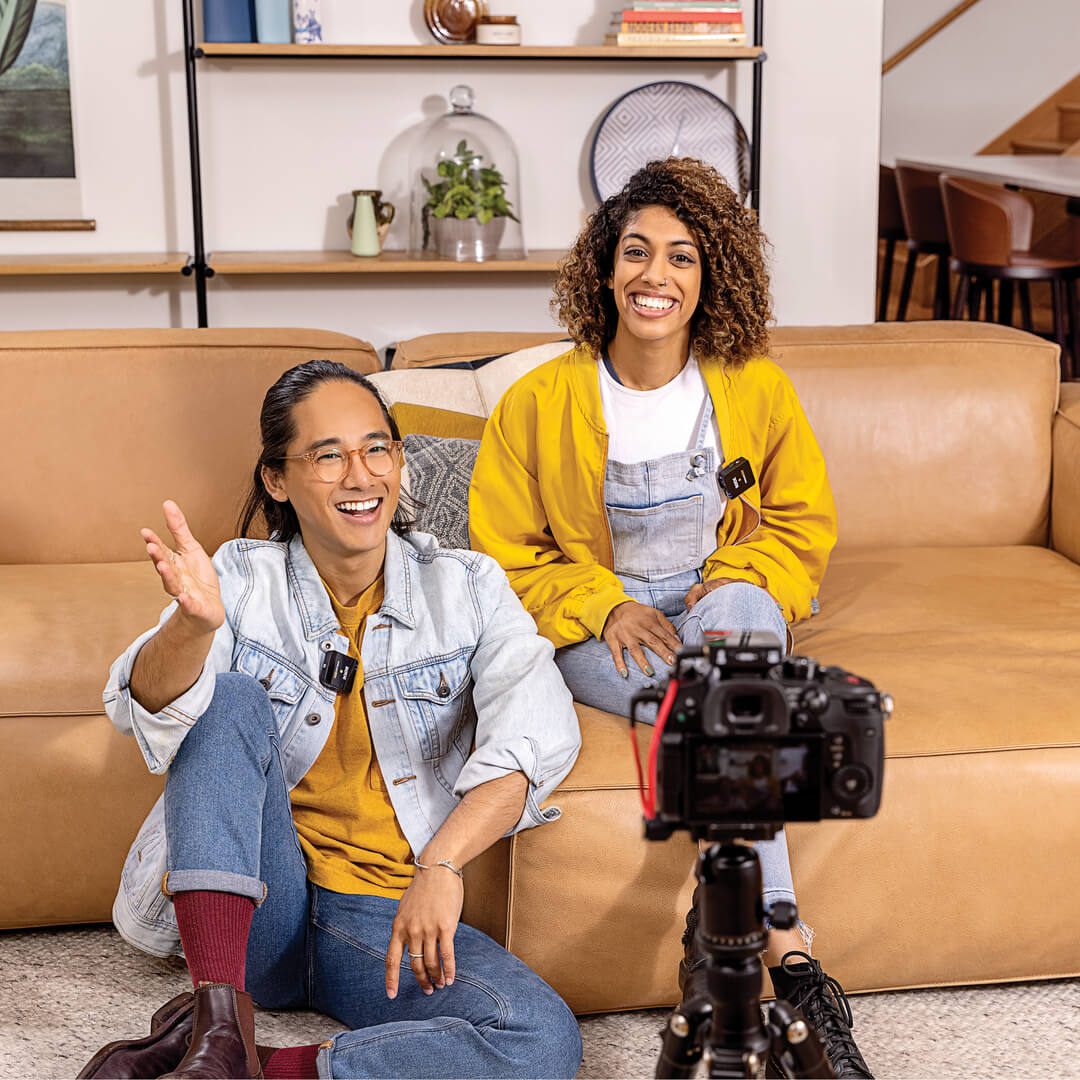 Couple doing couch recording in front of camera on tripod with Wireless GO II connected